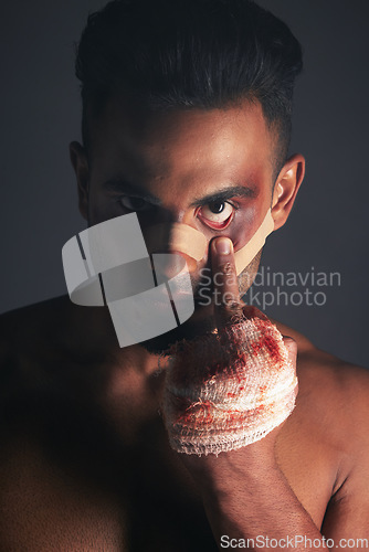 Image of Blood, boxing injury and man with bruise from fight conflict, criminal violence or dark crime with middle finger emoji sign. Shadow, rebel lifestyle and portrait of mma boxer with first aid bandage