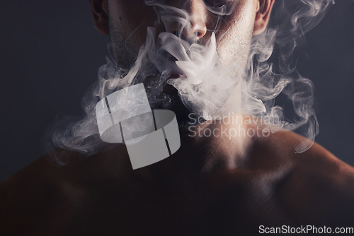 Image of Smoke, cloud and face of man with pollution for marijuana smoker health campaign with zoom. Cannabis, weed and cbd addiction model for smoking habit lifestyle advertising in black studio.