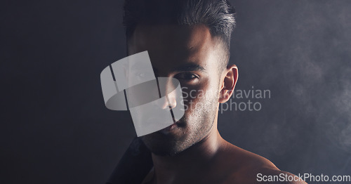 Image of Fitness, portrait and man in dark studio with smoke for competition, game or gym challenge training with mock up for marketing, advertising or promotion. Face, sports and power of sexy model headshot