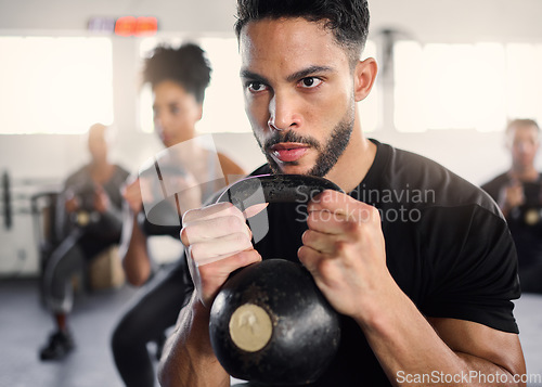 Image of Strong man, personal trainer and group training with kettlebell squat exercise, workout and fitness in gym club. Bodybuilder coach teaching sports class with heavy weights, challenge and powerlifting