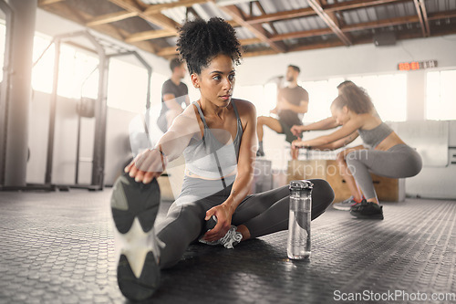 Image of Stretching, fitness and training with black woman in gym with water bottle for exercise, sports and workout. Health, wellness and energy with girl and legs warm up for performance, muscle and strong