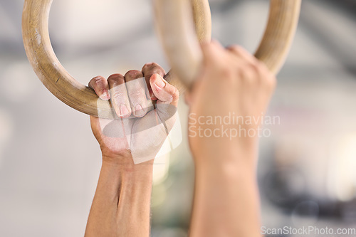 Image of Man, powder hands and gymnastics rings for exercise, training or workout performance for international sports competition. Zoom, gymnast and fitness athlete in routine performance at wellness center