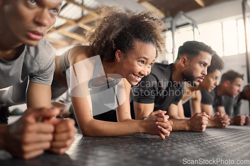 Image of Fitness, woman and plank exercise in group training gym for wellness, healthy lifestyle and workout. Strong, young and happy black girl, athlete and floor push up with friends for sports challenge