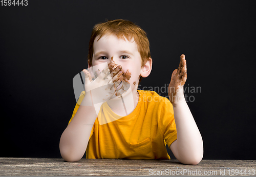 Image of boy smeared in milk chocolate