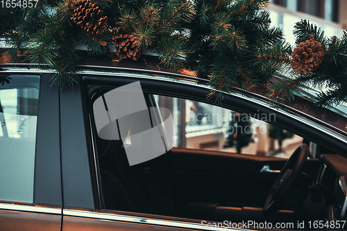 Image of Car with christmas tree on roof