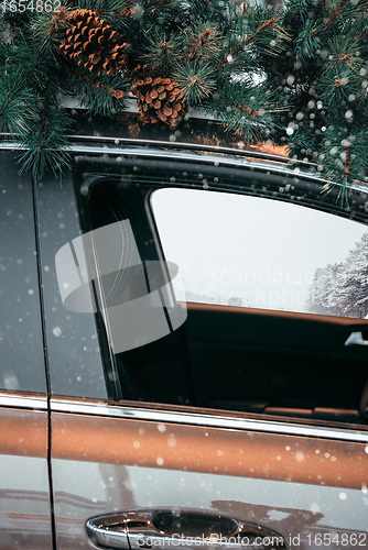 Image of Car with christmas tree on roof