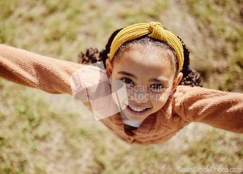 Image of Top view, child or girl in fun game pov in nature park, garden environment or sustainability grass field in summer break. Portrait, smile or happy youth kid playing or jumping or in energy activity