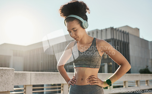 Image of Woman, tired or music headphones in fitness break, workout rest or Brazil city training in health, wellness or cardio. Thinking runner, sports athlete or personal trainer listening to exercise radio
