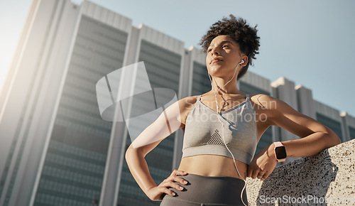 Image of Fitness, music and city black woman thinking of training, running or workout goals, motivation and wellness with 5g technology. Focus runner with sports electronics listening to audio for exercise