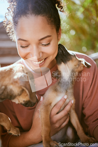 Image of Happy, care and girl playing with dogs at animal adoption center with excited smile holding puppy. Happiness, black woman and loyalty of foster pets with caring lick for bond and trust.