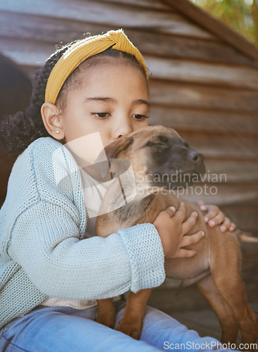 Image of Child, pet animal and kiss for love, care and happiness for dog, fun friend or partner. Black girl outdoor for adoptoion with healthy rescue puppy for development to learn responsibility and kindness