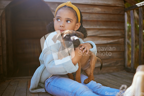Image of Girl child, animal shelter and dog hug, love and care while thinking about adoption. Pet, charity and kid hugging, embrace or cuddle with foster puppy, bonding and contemplating support for animal.