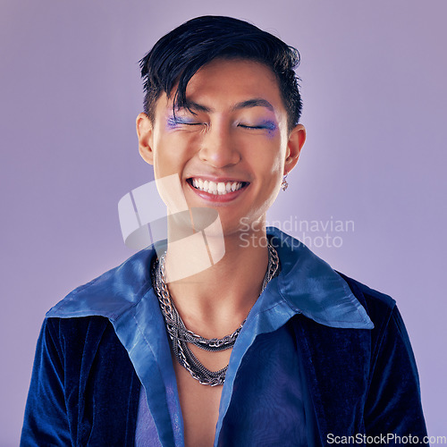 Image of Fashion, color and man in studio for punk, retro and pop art style while feeling happy with makeup and vintage clothes on a purple background. Lgbtq, gen z and asian aesthetic model with makeup