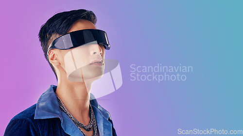 Image of Beauty, fashion and man with cyberpunk glasses in studio with blue and purple background. Creative, cosmetics and young male model with visor for futuristic style, techno and designer clothing