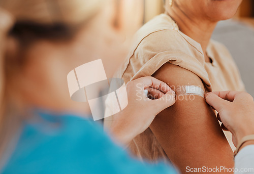 Image of Healthcare, patient and plaster on arm for covid vaccine, flu shot or arthritis or osteoarthritis injection in hospital for health and wellness. Woman and nurse or doctor together during consultation