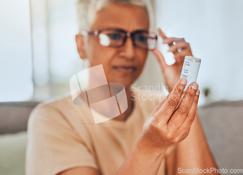 Image of Glasses, medicine and pills senior woman reading information for healthcare, insurance and wellness at home. Elderly or old woman check label bottle or container for medical pharmaceutical medication