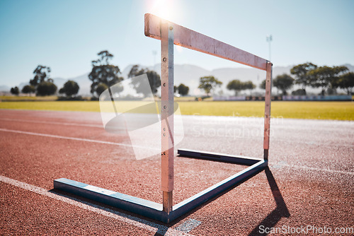 Image of Empty stadium, field and running hurdle or barrier at outdoors race track. Sports, athletics or jumping obstacle, metal equipment for runners or athletes for competition, exercise or training outside