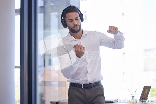Image of Businessman, headphones and dance to audio motivation in office for freedom or happiness. Man, music and listening online podcast in corporate workplace or disco dancing success celebration at desk