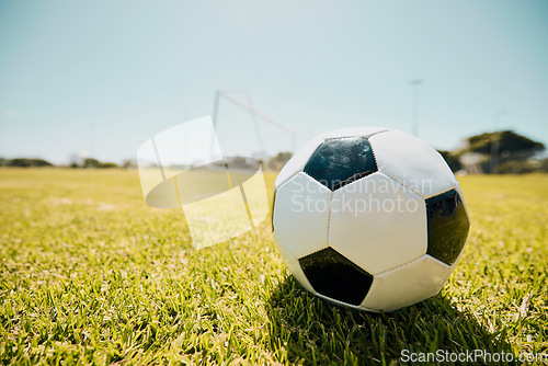 Image of Soccer, sports and fitness with a ball on a grass pitch or field ready to a game or match outdoor during summer. Football, soccer ball and mockup with sport equipment at an outside competition venue