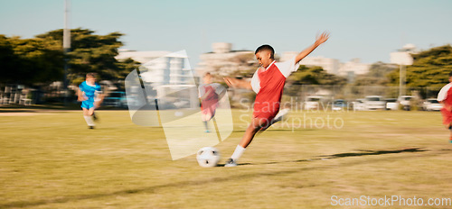 Image of Sports game, soccer and child shooting, kick or strike ball to score winning goal in contest, competition or match. Fitness workout, training exercise or youth soccer player playing on football field