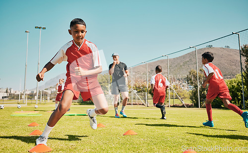 Image of Soccer, children and training or practice for sports competition or game on soccer field for fitness, exercise and energy. Football player, cone and sport with kids coach outdoor for team practice