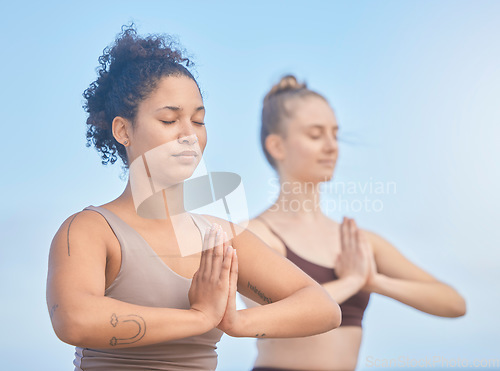 Image of Yoga, meditation and women with exercise in nature to relax, breathe and care for their mind. Fitness, motivation and friends training for wellness and hope with spiritual workout against a blue sky