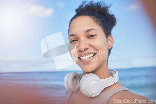 Image of Woman, fitness selfie, happy at beach with smile for workout, exercise or training. Exercise, healthy or sports health influencer woman for wellness motivation for 5g social media post with headphone