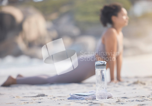 Image of Woman, zen yoga and stretching on beach with water for healthy relax meditation. Fitness balance exercise, chakra training and pilates mindset for wellness freedom on ocean sand with hydration drink