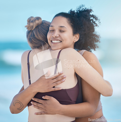 Image of Friends, women and hug after exercise outdoor, happy and calm at the beach with love and fitness together. Support, trust and friendship, workout motivation by the ocean and wellness with zen smile.