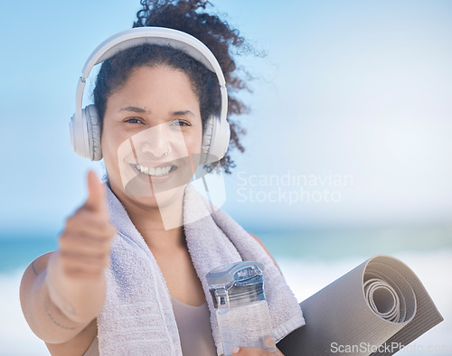 Image of Thumbs up, woman and headphone, fitness and exercise, yoga and motivation in Miami. Portrait of happy fitness female celebration, success and excited goal for achievement, yes sign and like emoji