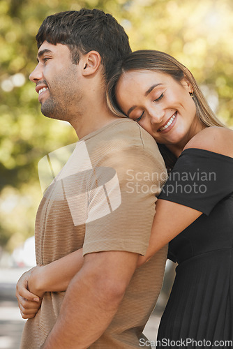 Image of Nature, love and happy woman hugging her husband from behind while on a romantic outdoor date. Happiness, smile and couple from Mexico embracing with care while on walk in a green garden or park.