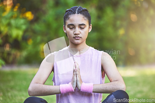Image of Woman, yoga and meditation for spiritual wellness, zen or calm exercise for the mind, body and health in nature. Female meditating in mindful awareness for healthy lifestyle and inner peace in a park