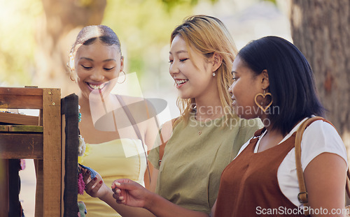 Image of Friends, women and shopping at market outdoor for souvenir, jewelry or toys. Choice, diversity and happy people shop together for discount sale, having fun time outdoors at park and bonding in nature