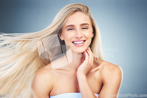 Image of Beauty, hair care and portrait of happy woman in studio with long, healthy and blond hair. Health, cosmetics and model from Australia with beautiful hairstyle after keratin, botox or salon treatment.