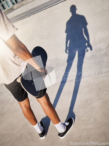 Image of Skateboard, city and man shadow skate in park athlete ready for training, fitness and skate park exercise. Sports, workout and person from Los Angeles with board on concrete for skateboarding sport