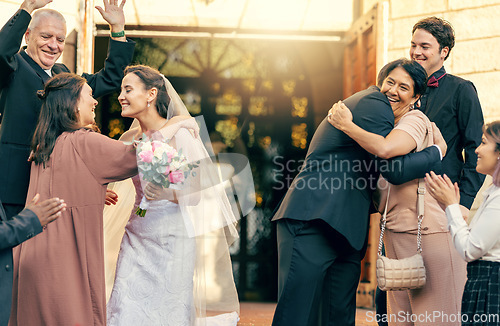Image of Family, wedding at church for the bride and groom hugging in celebration and happiness for marriage ceremony farewell. Happy married couple saying their good byes or celebrating together at the venue