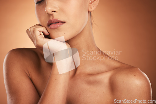 Image of Beauty, skincare and closeup of a woman in a studio with a natural skin routine for wellness. Cosmetics, face and face of a model with a facial treatment isolated by a gradient brown background.