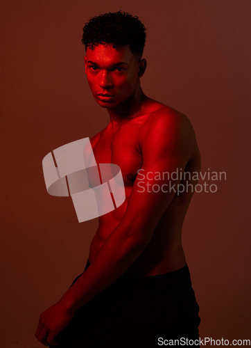 Image of Black man, body and dark light on red background in studio for exercise, training or workout bodybuilder, personal trainer or coach. Portrait, fitness model or red light aesthetic for health wellness