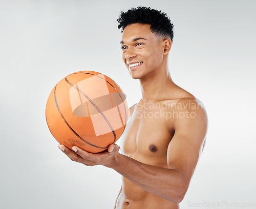 Image of Basketball, fitness and black man in studio training, exercise and wellness with smile for sports competition. Power, muscle and happy athlete, basketball player or model with a ball for game workout