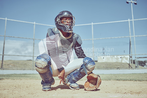 Image of Baseball, fitness and catcher on a baseball field training for a sports game in an outdoor exercise workout in summer. Focus, wellness and healthy black man in safety gear with a secret hand gesture