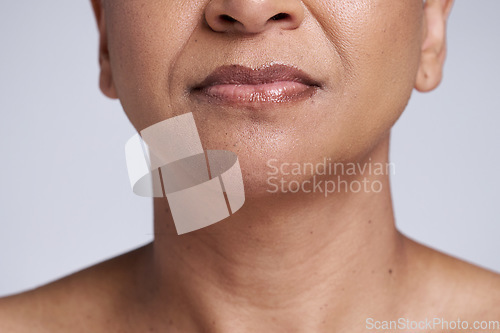 Image of Beauty, skincare and lips of senior woman isolated in studio for wellness, healthy and natural skin. Makeup, cosmetic and face closeup of black woman for anti aging beauty products on gray background