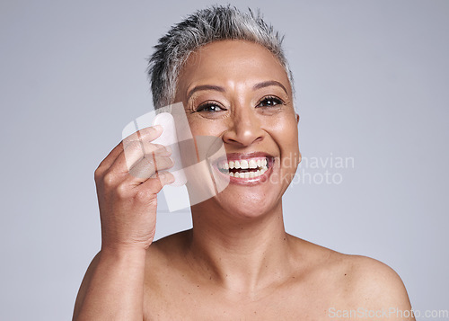 Image of Beauty, gua sha and skincare of a senior woman in studio for dermatology, cosmetics and facial massage on a grey background. Face portrait of a mature model happy about skin results with rose quartz