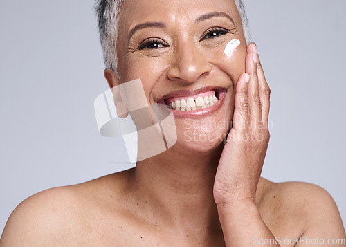 Image of Senior woman, sunscreen and face in studio, skincare cream product for natural uv protection or cosmetic wellness. Advertising beauty facial, happy elderly model with smile or dermatology spf lotion
