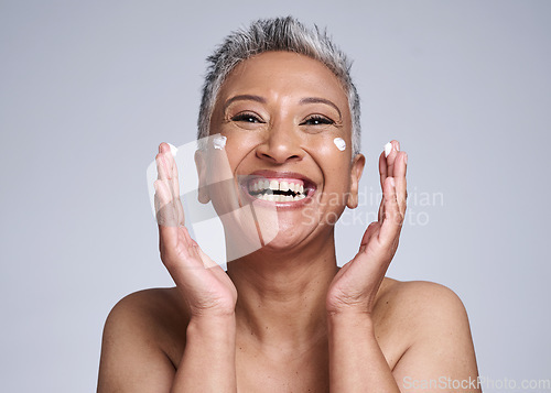 Image of Happy senior woman with skincare, beauty and healthy cosmetic skin with anti aging facial moisturizer cream. Portrait of health self care, lotion on face and smile in grey mockup studio background