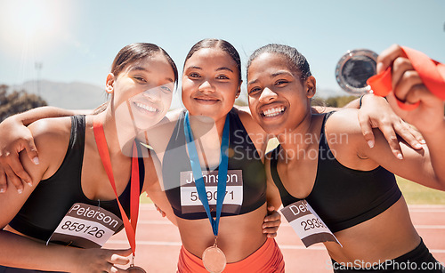 Image of Portrait, diversity and women with medals, for sports and winners on track, smile or victorious together. Champions, healthy girls or athlete happy with results on field, running victory or happiness