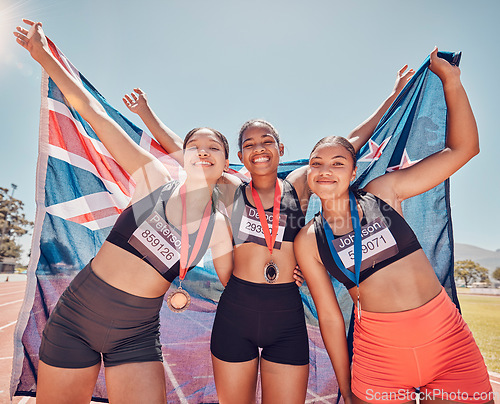 Image of Athlete, champion and winning group of women holding new Zealand flag and medal after competition, marathon and running at stadium. Portrait of diversity female runners happy about win or achievement