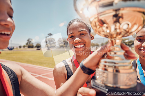 Image of Winner, trophy and track team celebrate olympic relay teamwork, sprint competition or marathon race victory. Award, goal achievement and success celebration for athlete friends, runner or black women