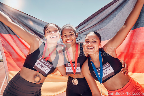 Image of Award, running and team of women with flag of Germany for winner, gold medal or training in stadium racetrack event. Fitness, goals or sports with portrait of girl runner for global marathon champion