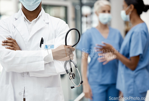 Image of Black man, doctor and stethoscope for health, crossed arms and for wellness in hospital. Medical professional, nurses and health with equipment for checkup, examine and healthcare in workplace.