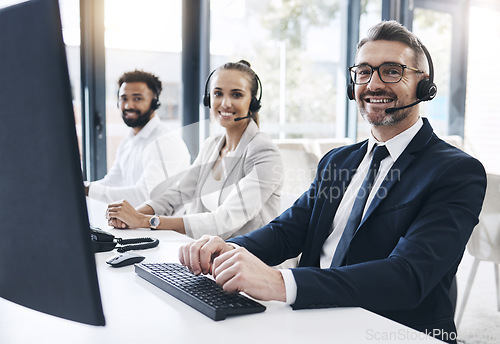 Image of Finance, contact us and financial consultant in a call center with diversity working in customer support. Smile, portrait and happy fintech telemarketing agents talking to clients in customer service